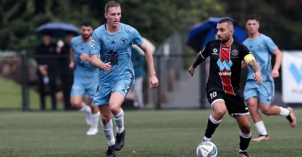 A Sharks player in sky blue runs past a Blacktown City player