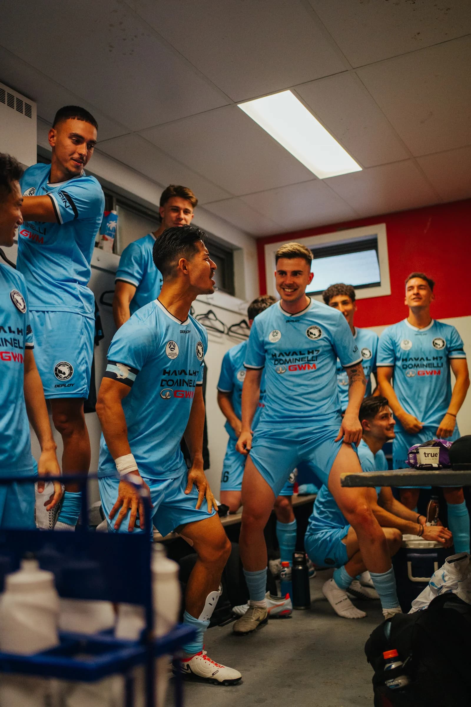 Sharks players celebrating together in the dressing room after the win