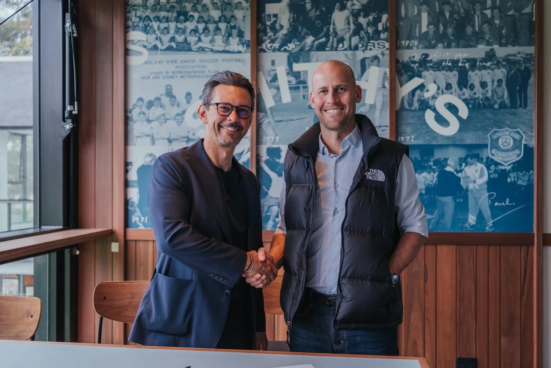 David Perkovic shakes hands with a club official in Smithy's