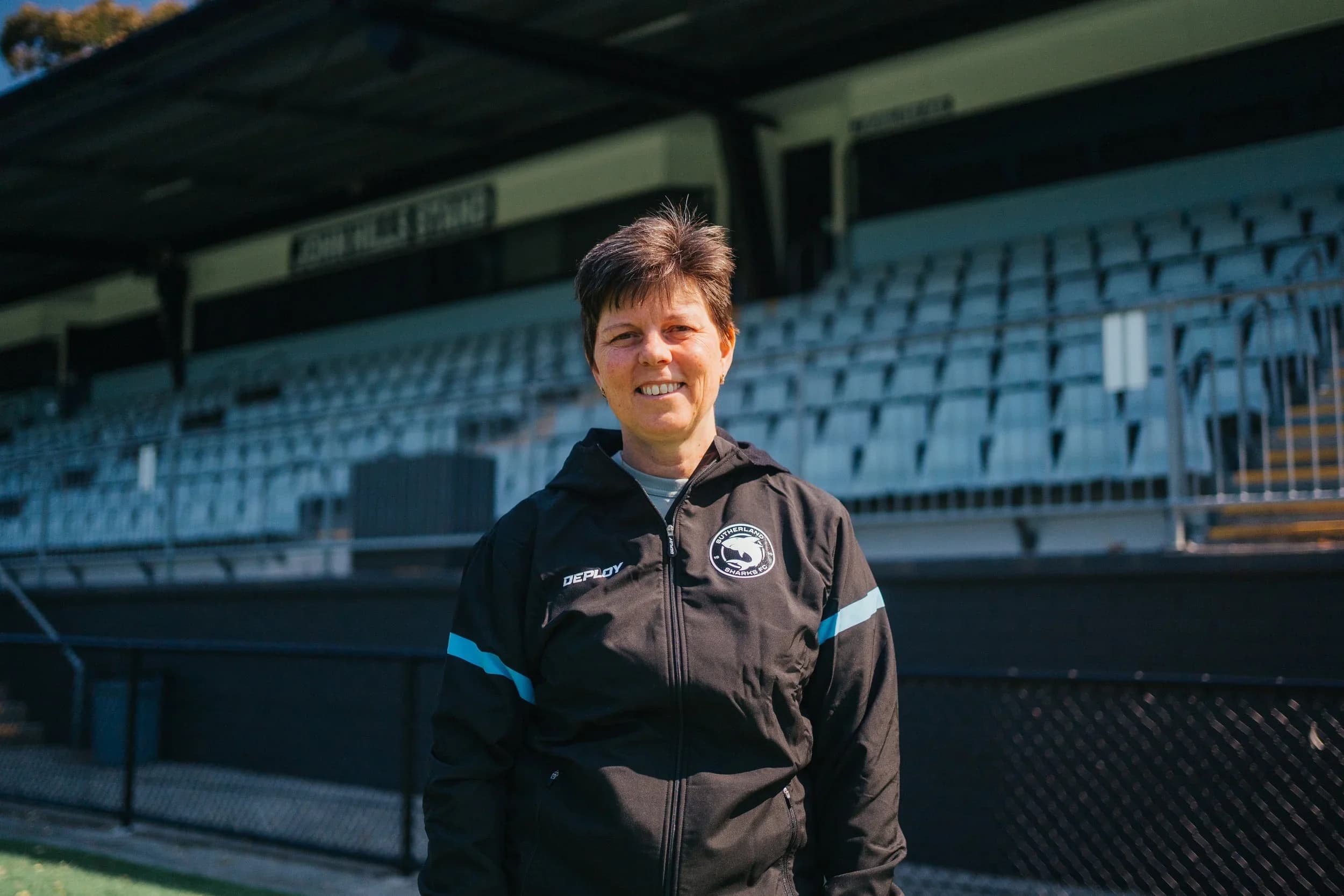 Debbie Fisher in a Sharks training jacket in front of the John Hills Grandstand