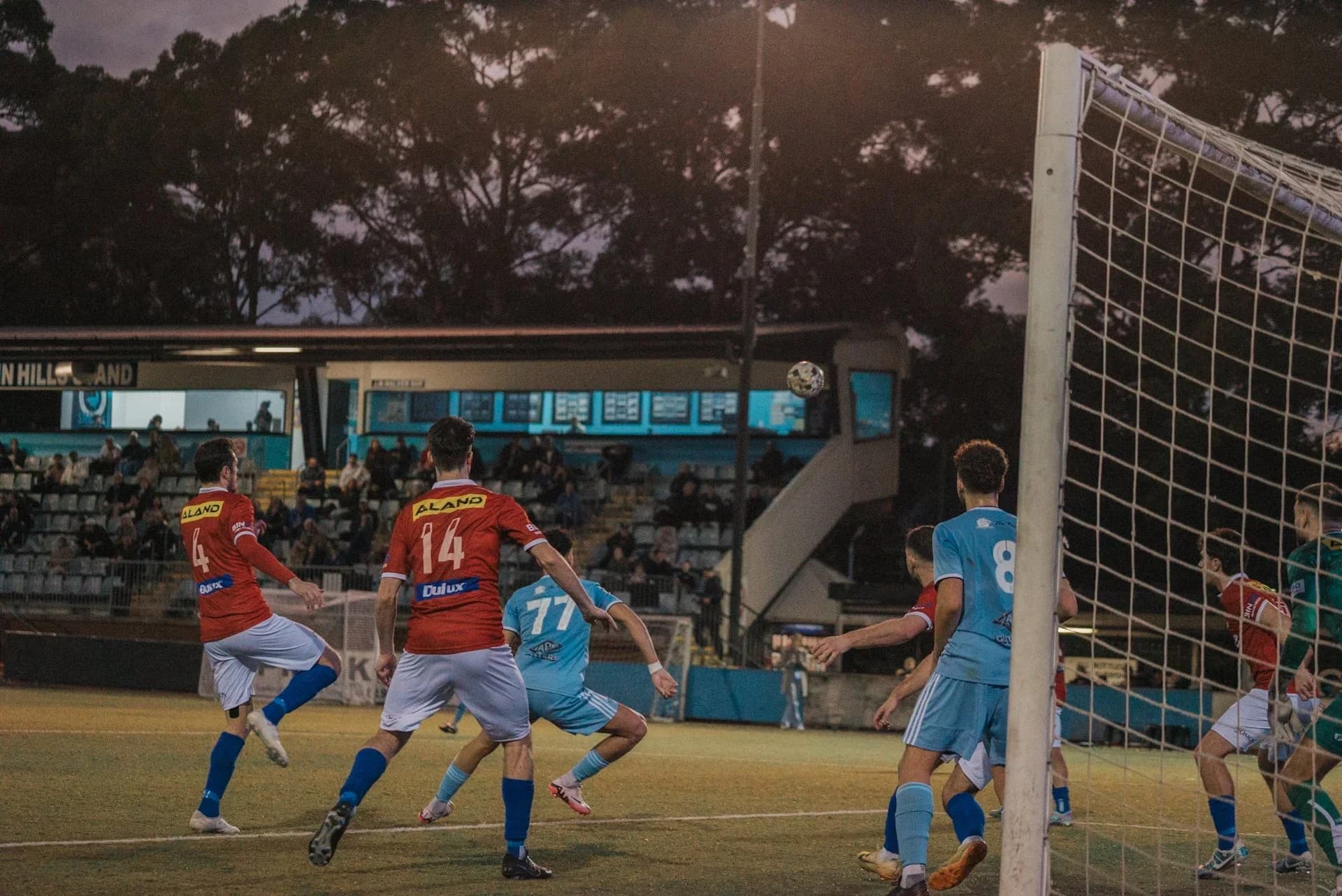 Players crowd the goalmouth as a corner comes in against Sydney United