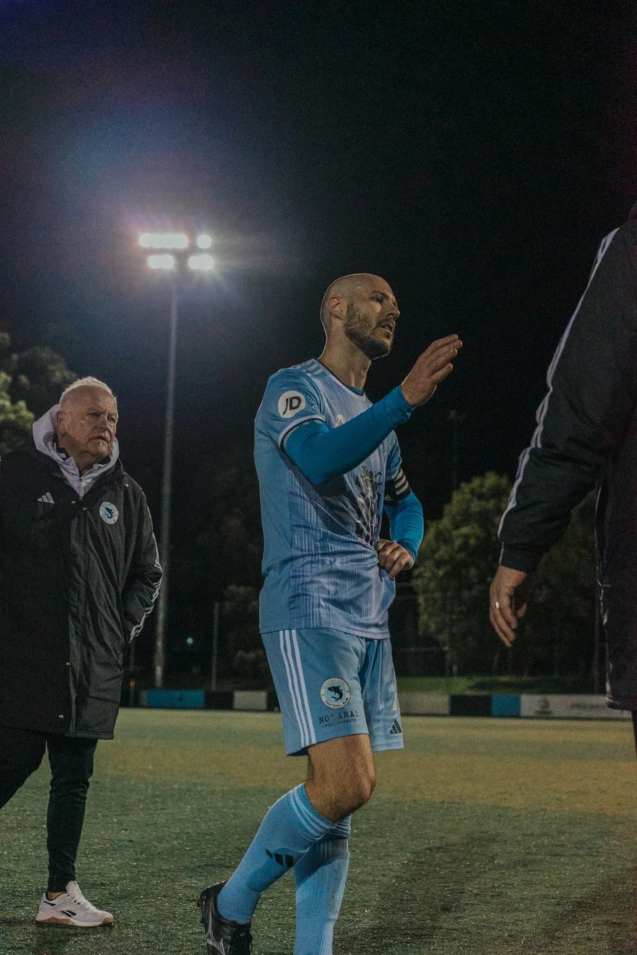 A Sharks player walks off the pitch at night after the loss to St George City