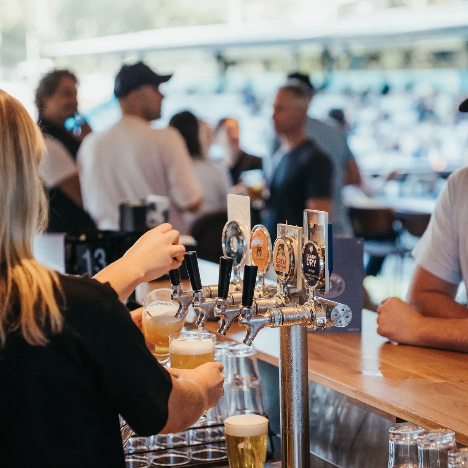 A bartender pours beers at the Smithy's bar
