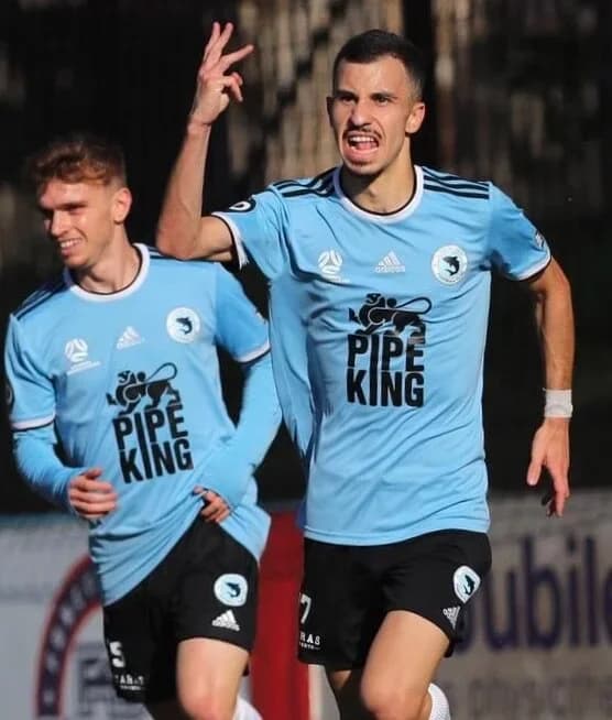 Andrew celebrates a goal with a teammate