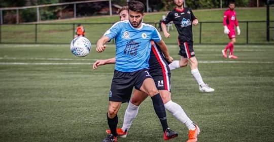 Peter Simonoski in sky blue on the ball during a match