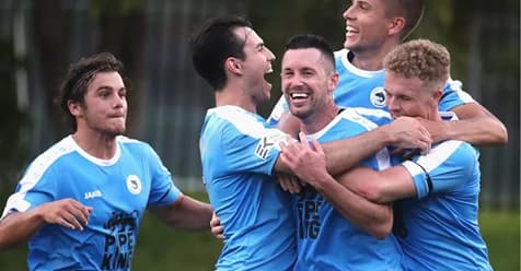 Sharks players in sky blue celebrate a goal together