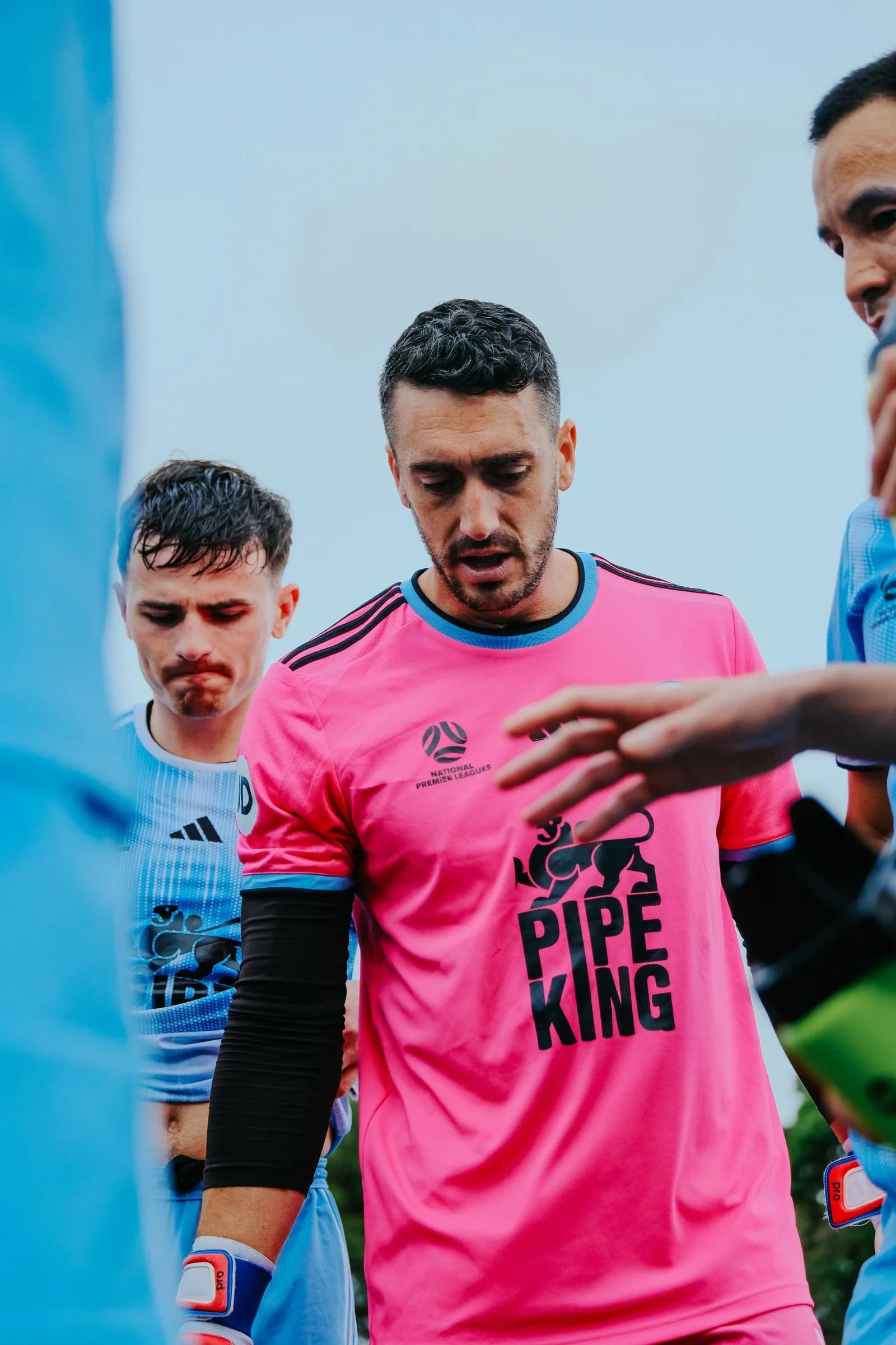 The Sharks goalkeeper in pink with teammates after the win over Marconi