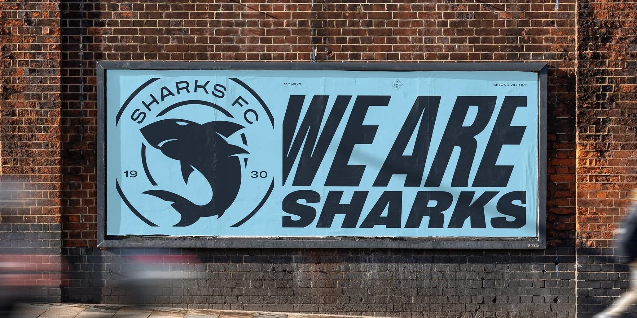 A We Are Sharks sign with the new crest on a brick wall