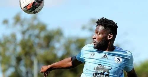 A Sharks player in sky blue volleys the ball