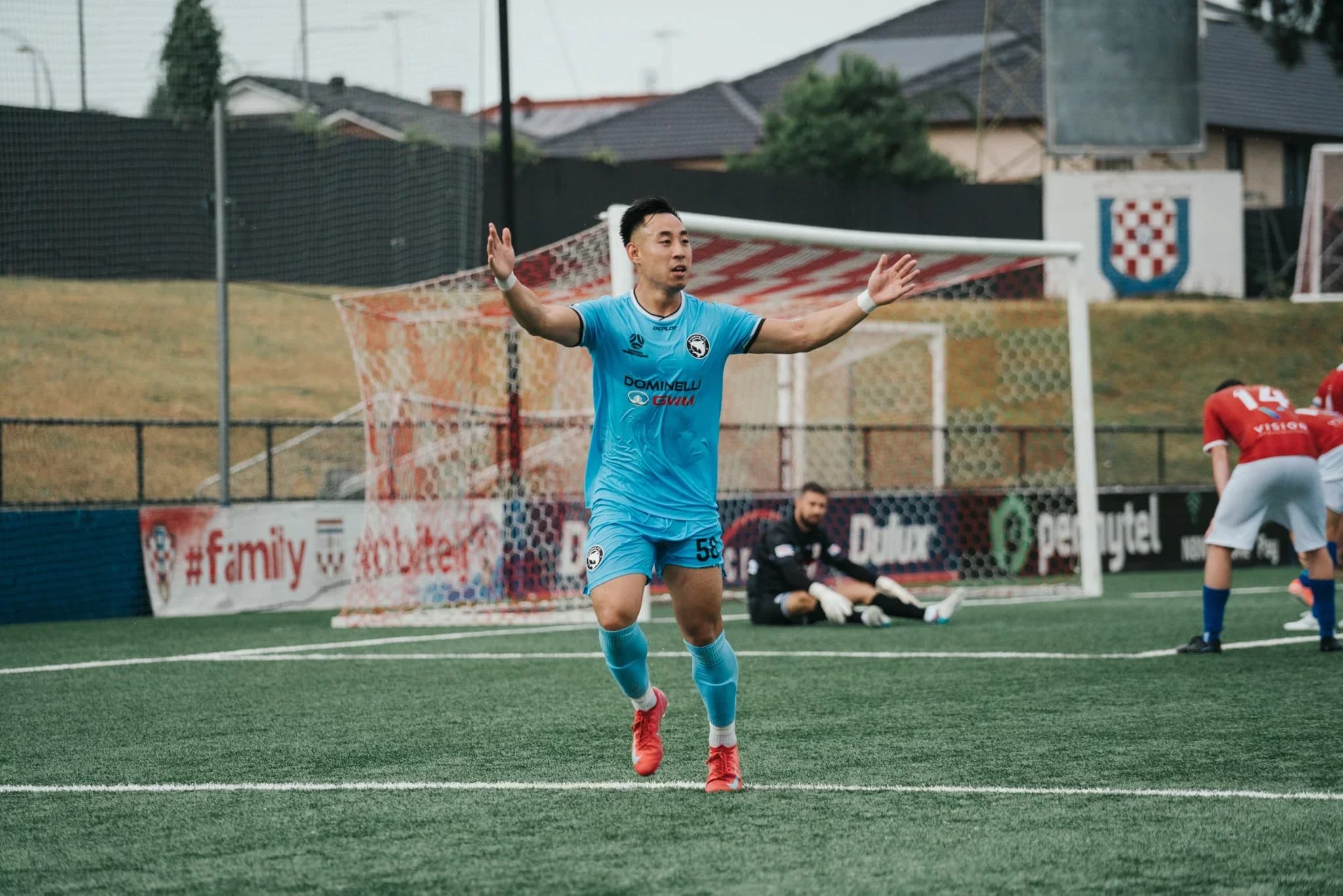 A Sharks player in sky blue celebrates a goal against Sydney United