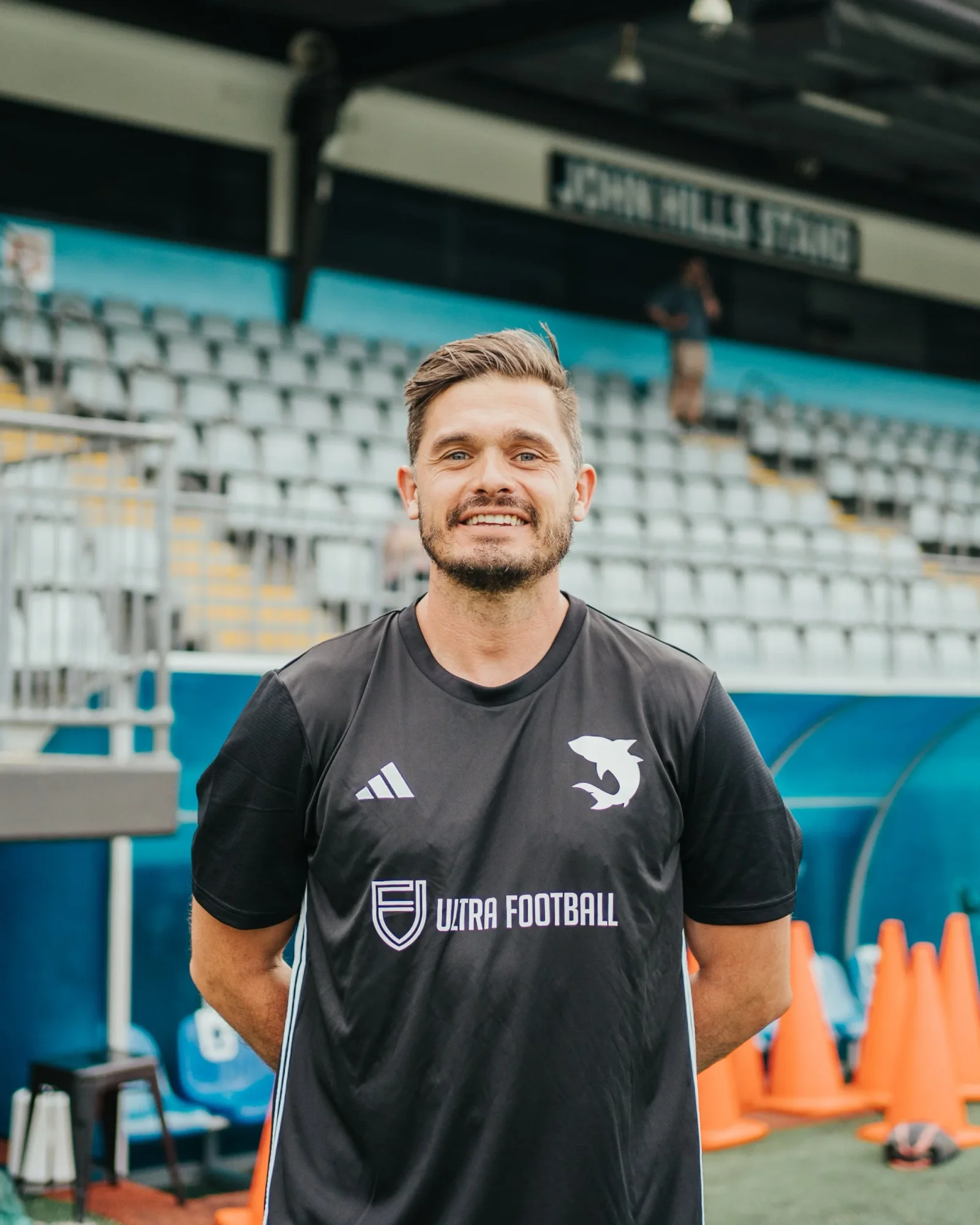 The Sharks strength and conditioning coach in the grandstand
