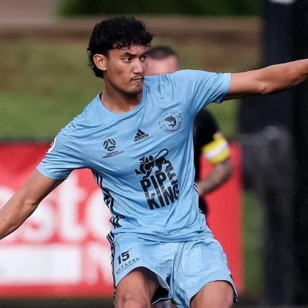 A Sharks player in sky blue on the ball against Wanderers