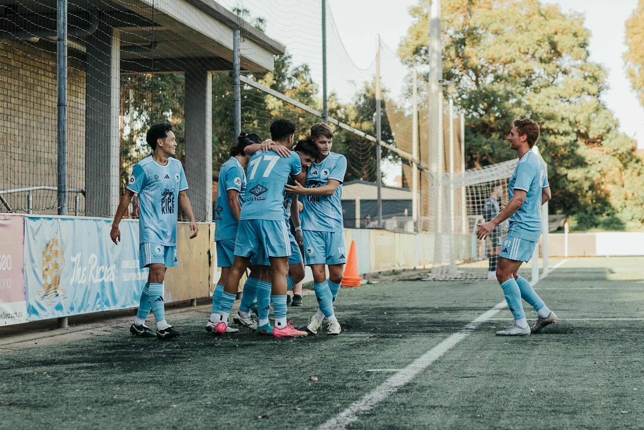 Sharks players celebrate together after the win over Hills United