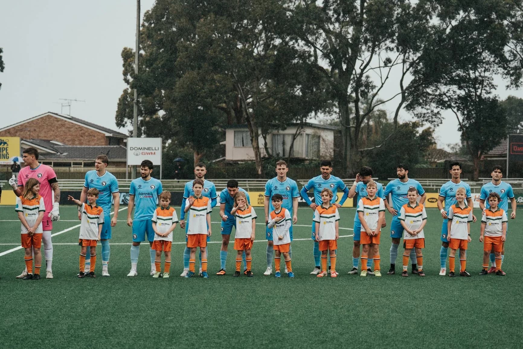 The Sharks and APIA line up with junior mascots before kick-off