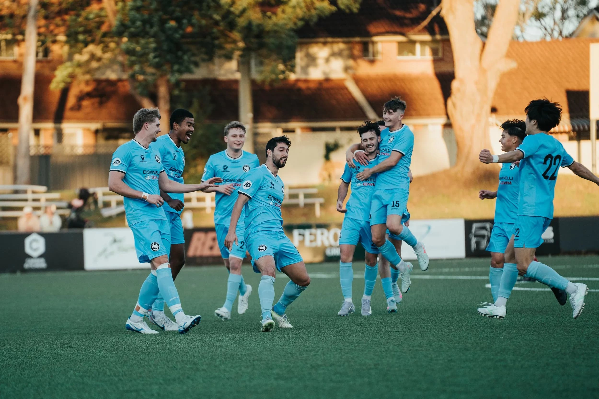 Sharks players celebrate a goal together at sunset