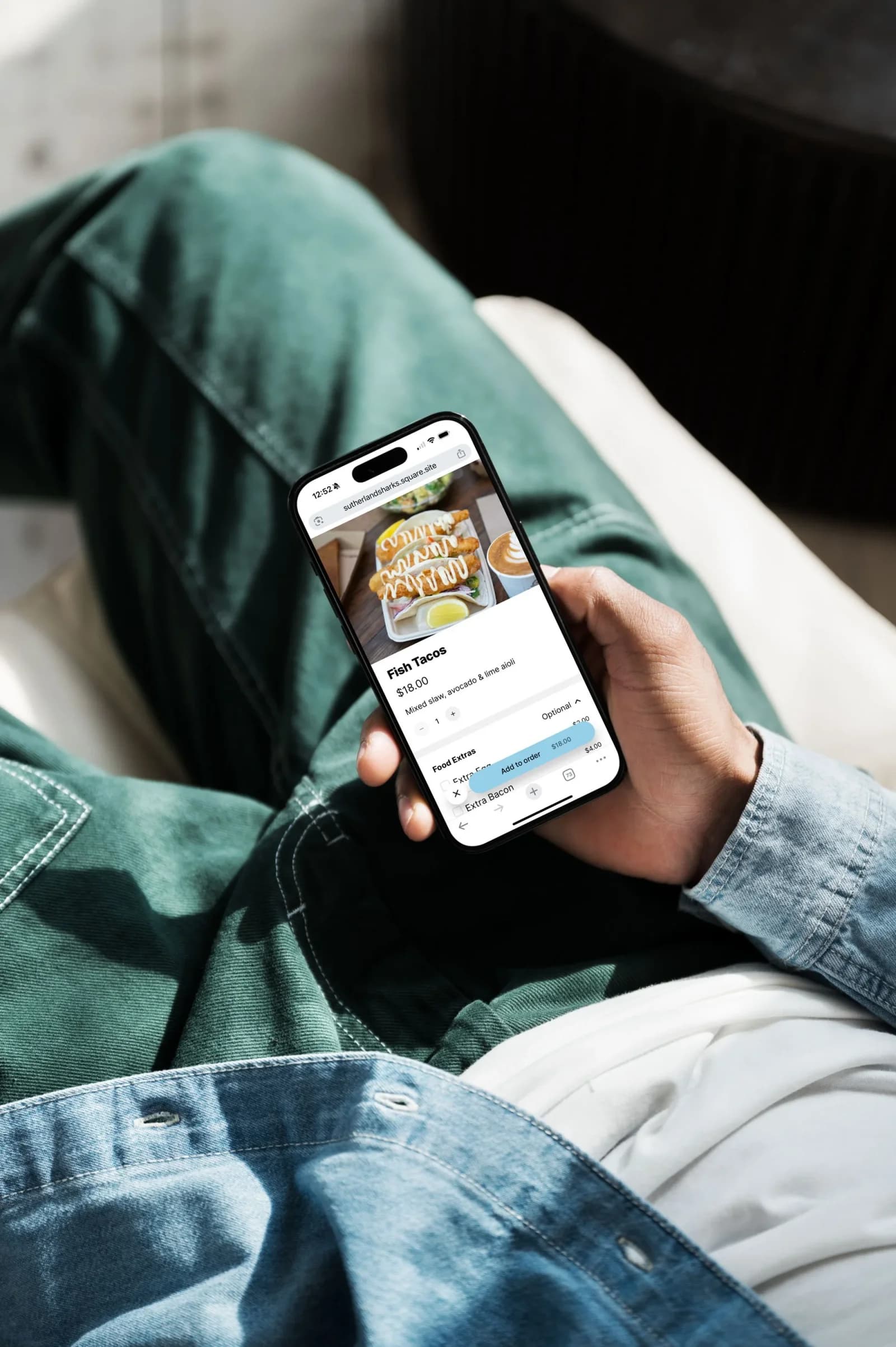A fan orders food and drink on a phone app from their seat