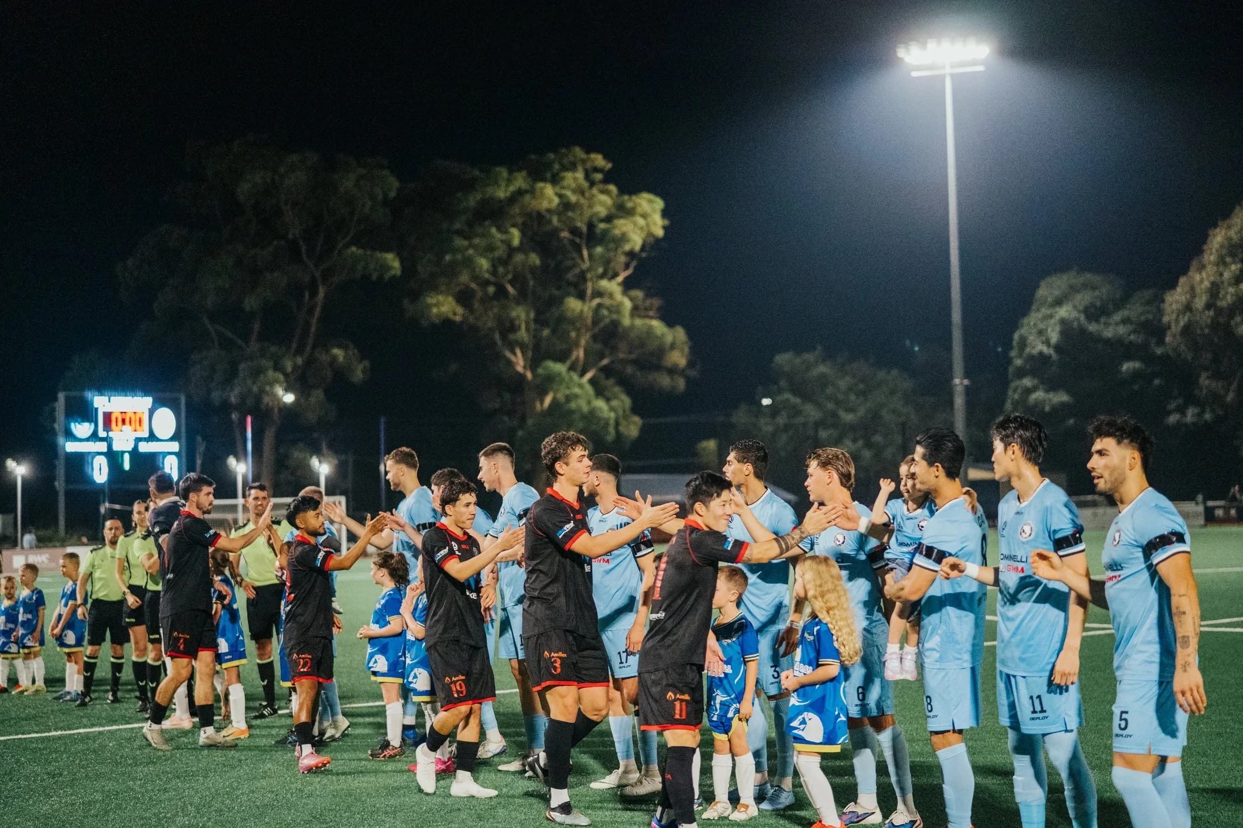 The Sharks and Blacktown City shake hands before kick-off under the floodlights