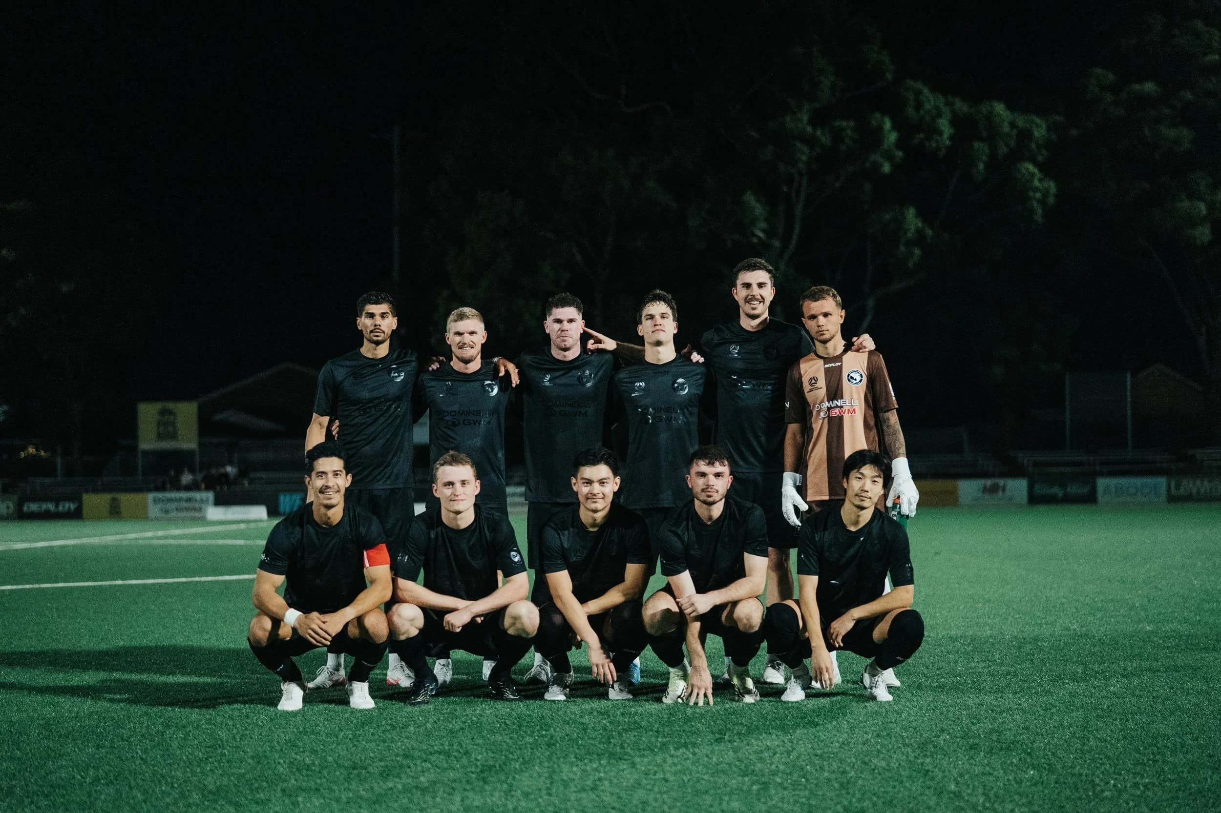 The Sharks team photo in black training tops at night before the Australia Cup match