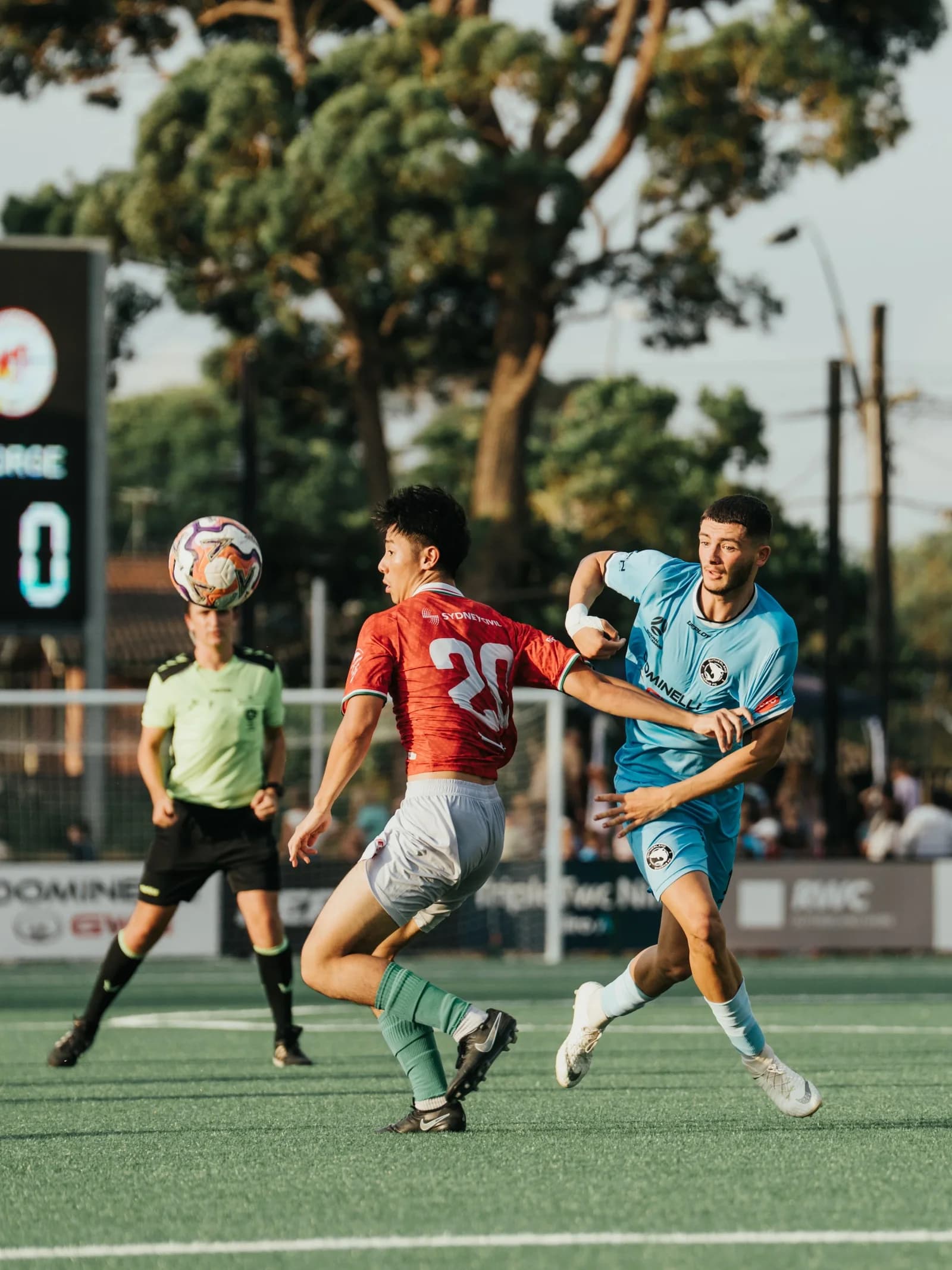 A Sharks player and a St George player in red contest the ball in the air