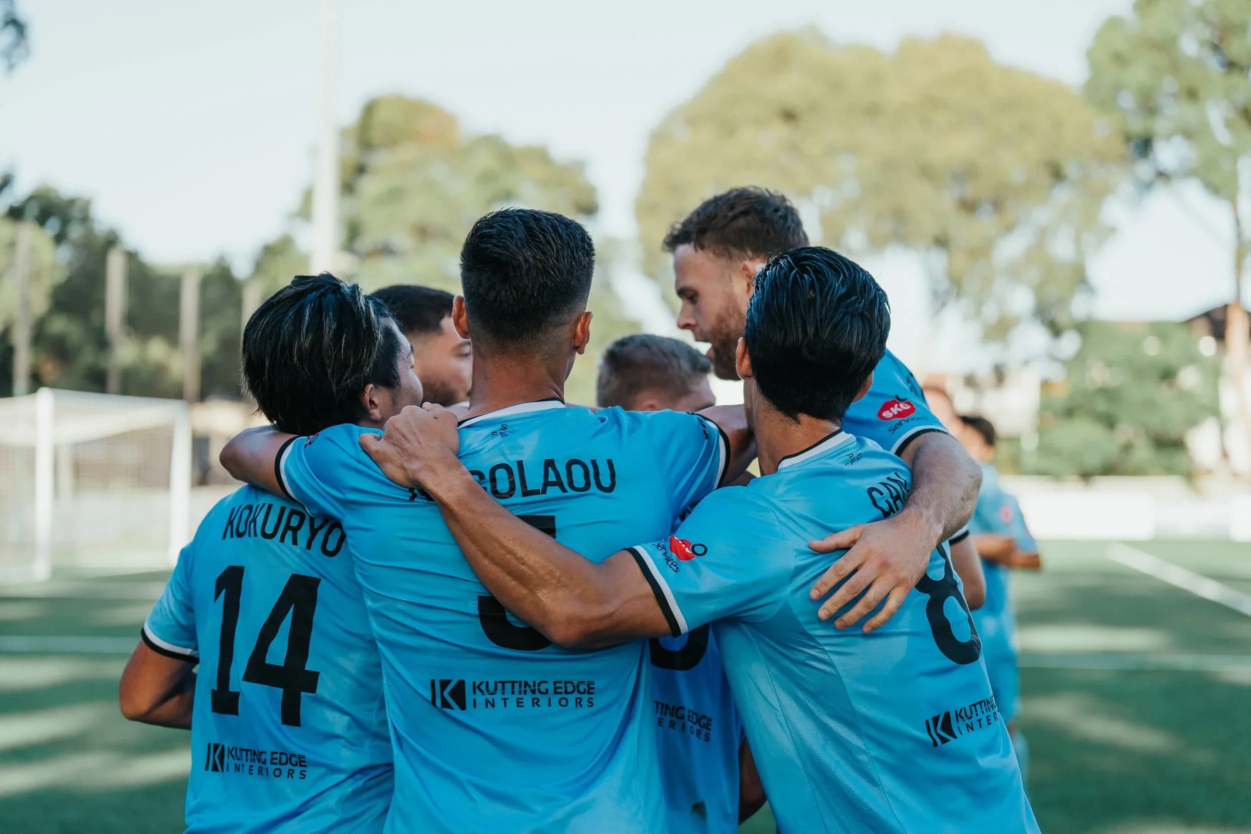 Sharks players embrace to celebrate the win